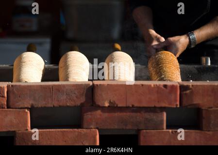 Baking a  spit cake (Kürtőskalács) Stock Photo