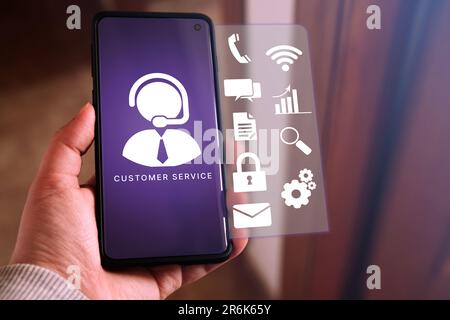 Woman use smartphone to contact with a customer service. Holographic interface. Customer support hotline people connect. Feedback. Stock Photo