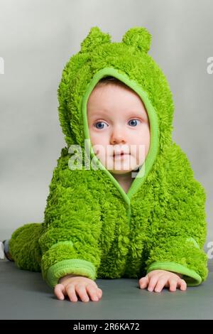 A cute cute baby in a furry frog costume Stock Photo