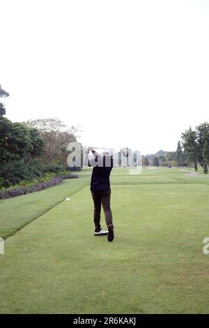 Jakarta, Indonesia - June 5, 2023 : Golf player on golf course. Golfer taking a shot. Stock Photo