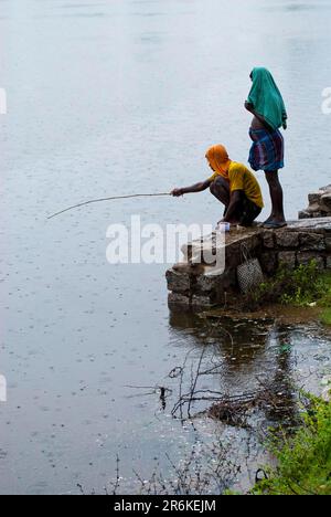 Village people angling during a rainy day, Tamil Nadu, South India, India, Asia Stock Photo