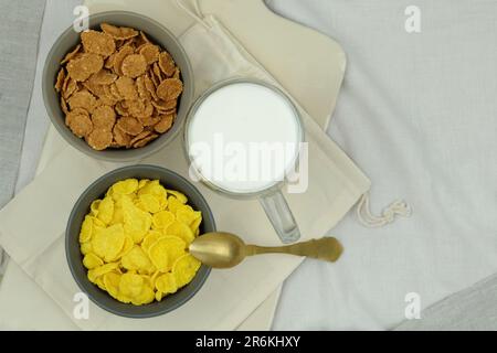 Bowl with cornflakes on grey background Stock Photo - Alamy