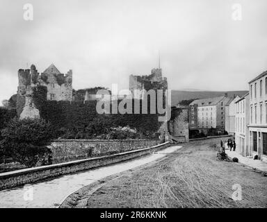 A late 19th century view of Cahir Castle, in County Tipperary, one of the largest castles in Ireland. Sited on an island in the river Suir, as it flows through Cahir town centre, it was built from 1142 by Conchobar Ua Briain, King of Thomond. The core structure of the castle dates to construction in the 13th century by the O'Brien family. Granted to the powerful Butler family in late 14th century, the castle was enlarged and remodelled between the 15th and 17th centuries. It fell into ruin in the late 18th century and was partially restored in the 1840s when the Great Hall was partly rebuilt. Stock Photo