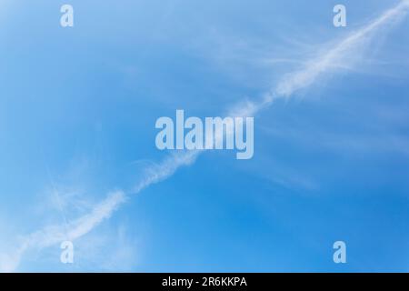 Trail line from a flying plane on a beautiful blue sky. Airplane trail. chemical trail in the sky from an aircraft. Stock Photo