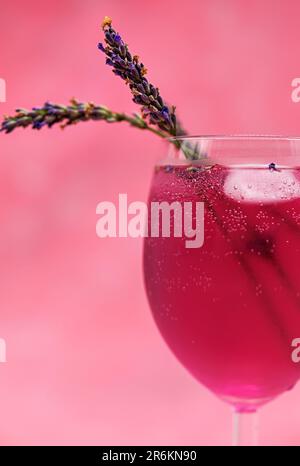 A glass of pink cocktail on a gradient magenta background Stock Photo