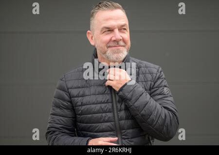 Middle age man looks aside in anticipation of something nice Stock Photo