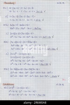 School student's notes on mathematics in a school notebook about rules and examples of solving mathematical expressions with polynomials Stock Photo