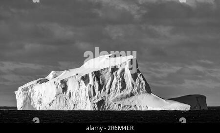 Tilted Fragment of Tabular Iceberg in Bellingshausen Sea, Antarctica Stock Photo