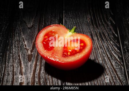 sliced red tomato on wood background Stock Photo