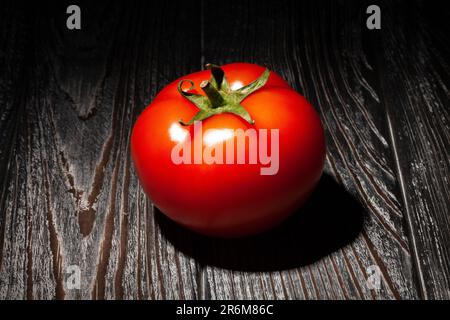 red tomato on wood background Stock Photo