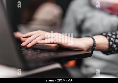 Persons typing on the laptop hands in focus Stock Photo