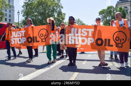 London, UK. 10th June, 2023. Just Stop Oil activists holding Just Stop Oil banners pass through Whitehall as they continue their daily slow march demanding that the government stops issuing new fossil fuel licences. Credit: SOPA Images Limited/Alamy Live News Stock Photo