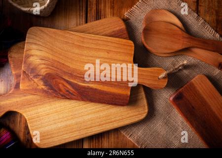 Empty rustic wooden cutting board for kitchen on old rustic wooden table. Table top view view. Stock Photo