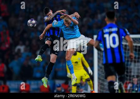 Inter Milan's Alessandro Bastoni, left, heads the ball past Manchester  City's Erling Haaland during the Champions League final soccer match  between Manchester City and Inter Milan at the Ataturk Olympic Stadium in