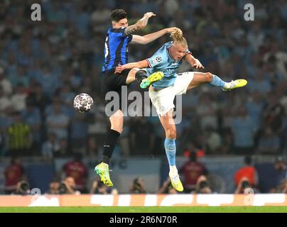 Inter Milan's Alessandro Bastoni, left, heads the ball past Manchester  City's Erling Haaland during the Champions League final soccer match  between Manchester City and Inter Milan at the Ataturk Olympic Stadium in