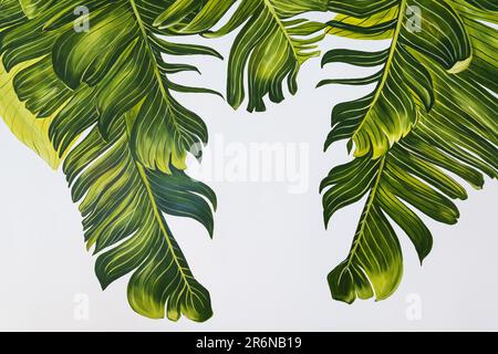 Tropical palm leaves are beautifully painted with acrylic paint in different shades of green Stock Photo