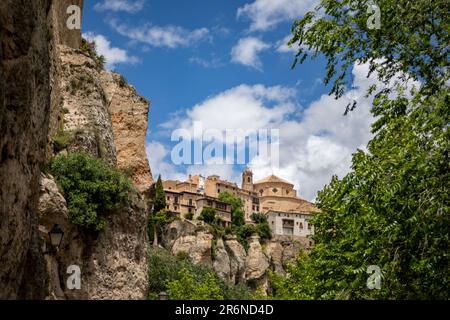 Beautiful partial view between trees and rocks of the Unesco heritage monumental city of Cuenca Stock Photo