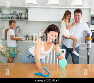 Mom is dusting the table. Father with children vacuuming room Stock ...