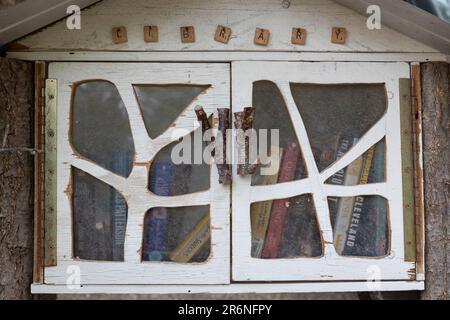 Detail of a rustic little free library along Acequia Madre in Santa Fe, New Mexico. Stock Photo