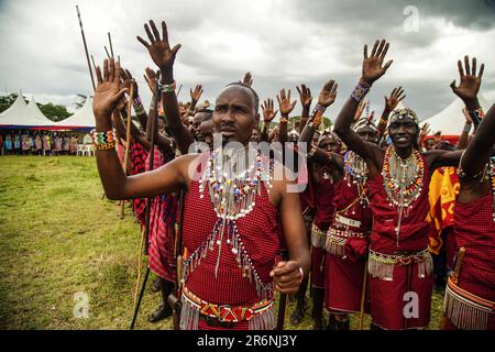 Narok, Kenya. 10th June, 2023. Maasai men wearing their traditional attires raise their hands during The Maasai Cultural Festival in Narok, near The Maasai Mara National Reserve. In their inaugural cultural festival, The Maasai sang, danced and showcased their dressing as well as their rituals. Credit: SOPA Images Limited/Alamy Live News Stock Photo