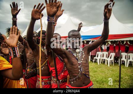 Narok, Kenya. 10th June, 2023. Maasai men wearing their traditional attires raise their hands during The Maasai Cultural Festival in Narok, near The Maasai Mara National Reserve. In their inaugural cultural festival, The Maasai sang, danced and showcased their dressing as well as their rituals. Credit: SOPA Images Limited/Alamy Live News Stock Photo