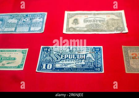 Close up view of old Indonesian banknotes. Old rupiah currency, money concept. Selected focus. Stock Photo
