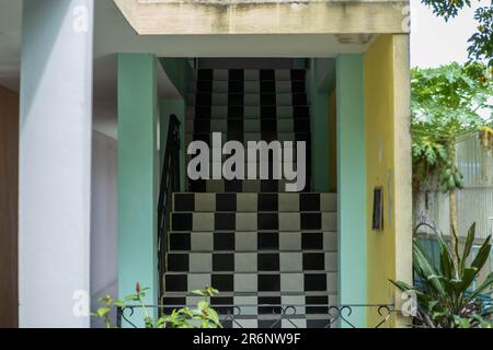 Long black and white tiled staircase in the building. building entrance stairs Stock Photo