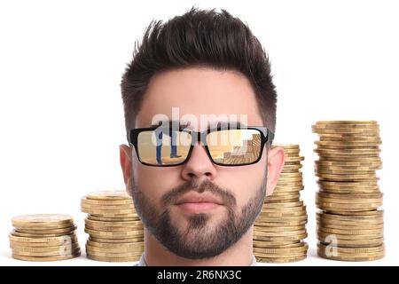 Steps to success. Confident man against stacked coins on white background. Businessman climbing up stairs of wooden blocks, reflection in sunglasses Stock Photo