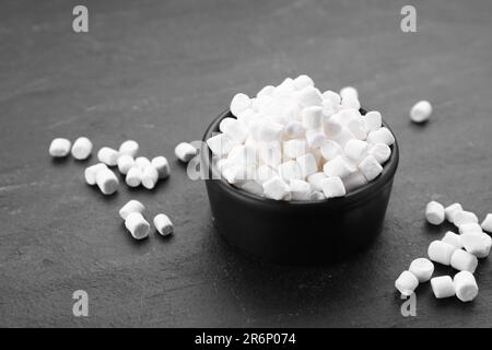 Bowl with delicious marshmallows on black background Stock Photo