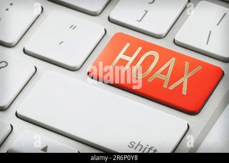 Red button with word Hoax on laptop keyboard, closeup Stock Photo