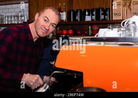 MELBOURNE, AUSTRALIA - June 01: The Avenue Food Store's owner, Yarra, is busy making coffees as he  opens his doors to customers after 3 months on 01 June, 2020 in Melbourne, Australia. Victoria is open for business as cafes, bars and restaurants once again open their doors for a maximum of 20 sit down patrons from today. The Victorian Premier Daniel Andrews, announced on the 16th May that all cafes, restaurants and bars will  be able to reopen for up to 20 patrons per enclosed space from the 1st of June and then a further easing of restrictions to 50 patrons on the 22nd of June. It comes as w Stock Photo