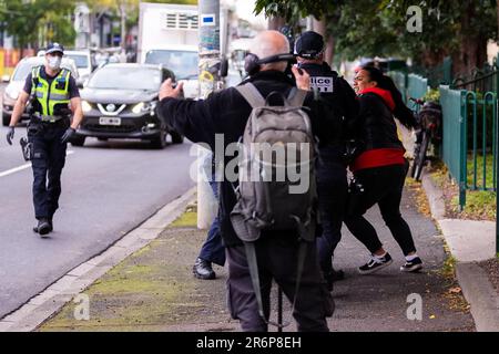 MELBOURNE, AUSTRALIA - JULY 7: A woman standing on the street in support of the residents inside of 120 Racecourse road is violently slammed to the ground and arrested as police swarm on a small number of people amid the third full day of the total lockdown of 9 housing commission high rise towers in North Melbourne and Flemington during COVID 19 on 7 July, 2020 in Melbourne, Australia. After recording a horror 191 COVID-19 cases overnight forcing Premier Daniel Andrews to announce today that all of metropolitan Melbourne along with one regional centre, Mitchell Shire will once more go back to Stock Photo