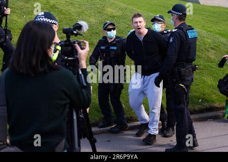 MELBOURNE, VIC - SEPTEMBER 05: Police arrest a man during the Anti-Lockdown Protest on September 05, 2020 in Sydney, Australia. Stage 4 restrictions are in place from 6pm on Sunday 2 August for metropolitan Melbourne. This includes a curfew from 8pm to 5am every evening. During this time people are only allowed to leave their house for work, and essential health, care or safety reasons. Stock Photo