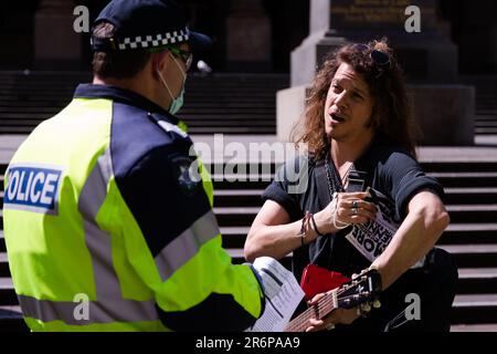 MELBOURNE, VIC - SEPTEMBER 19: A freedom protester speaks to police at the State Library during the Freedom protest on September 19, 2020 in Melbourne, Australia. Freedom protests are being held in Melbourne every Saturday and Sunday in response to the governments COVID-19 restrictions and continuing removal of liberties despite new cases being on the decline. Victoria recorded a further 21 new cases overnight along with 7 deaths. Stock Photo