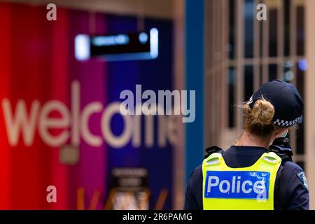 MELBOURNE, VIC - SEPTEMBER 20: A police officer stands guard near a welcome sign in the Chadstone Shopping Centre after a small protest was held during a series of pop up Freedom protests on September 20, 2020 in Melbourne, Australia. Freedom protests are being held in Melbourne every Saturday and Sunday in response to the governments COVID-19 restrictions and continuing removal of liberties despite new cases being on the decline. Victoria recorded a further 14 new cases overnight along with 7 deaths. Stock Photo