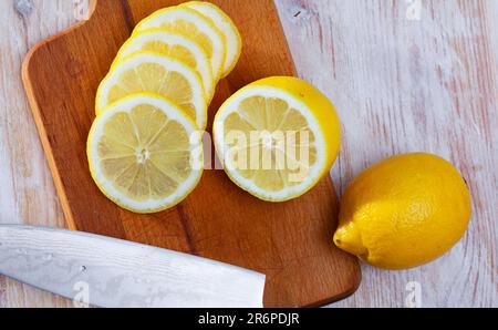 Sliced lemons on wooden table Stock Photo