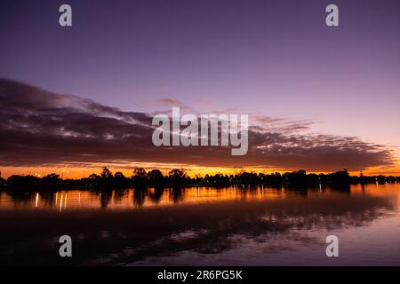 MELBOURNE, AUSTRALIA - APRIL 27: The sun sets behind Albert Park Lake during COVID 19 on 27 April, 2020 in Melbourne, Australia. Stock Photo