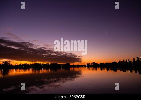 MELBOURNE, AUSTRALIA - APRIL 27: The sun sets behind Albert Park Lake during COVID 19 on 27 April, 2020 in Melbourne, Australia. Stock Photo