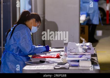 MELBOURNE, AUSTRALIA - APRIL 30: A nurse wearing full PPE processes tests at Footscray Bunnings, one of Melbourne's new mobile testing sites during COVID 19 on 30 April, 2020 in Melbourne, Australia. Stock Photo