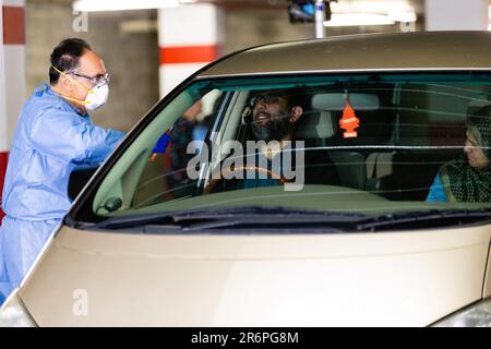 MELBOURNE, AUSTRALIA - APRIL 30: A nurse wearing full PPE takes swabs in the Pacific Epping Shopping Centre where one of the new mobile testing sites is located during COVID 19 on 30 April, 2020 in Melbourne, Australia. Stock Photo