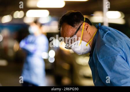 MELBOURNE, AUSTRALIA - APRIL 30: A nurse wearing full PPE takes swabs in the Pacific Epping Shopping Centre where one of the new mobile testing sites is located during COVID 19 on 30 April, 2020 in Melbourne, Australia. Stock Photo