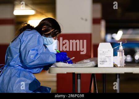 MELBOURNE, AUSTRALIA - APRIL 30: A nurse wearing full PPE processes tests at the Pacific Epping Shopping Centre as mobile testing sites pop up all over Melbourne during COVID 19 on 30 April, 2020 in Melbourne, Australia. Stock Photo