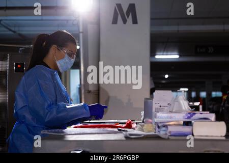 MELBOURNE, AUSTRALIA - APRIL 30: A nurse wearing full PPE processes tests at the Pacific Epping Shopping Centre as mobile testing sites pop up all over Melbourne during COVID 19 on 30 April, 2020 in Melbourne, Australia. Stock Photo