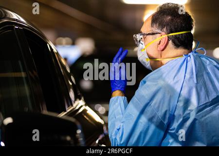 MELBOURNE, AUSTRALIA - APRIL 30: A nurse wearing full PPE takes swabs in the Pacific Epping Shopping Centre where one of the new mobile testing sites is located during COVID 19 on 30 April, 2020 in Melbourne, Australia. Stock Photo