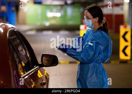 MELBOURNE, AUSTRALIA - APRIL 30: A nurse wearing full PPE takes swabs in the Pacific Epping Shopping Centre where one of the new mobile testing sites is located during COVID 19 on 30 April, 2020 in Melbourne, Australia. Stock Photo