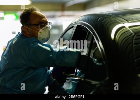 MELBOURNE, AUSTRALIA - APRIL 30: A nurse wearing full PPE takes swabs in the Pacific Epping Shopping Centre where one of the new mobile testing sites is located during COVID 19 on 30 April, 2020 in Melbourne, Australia. Stock Photo