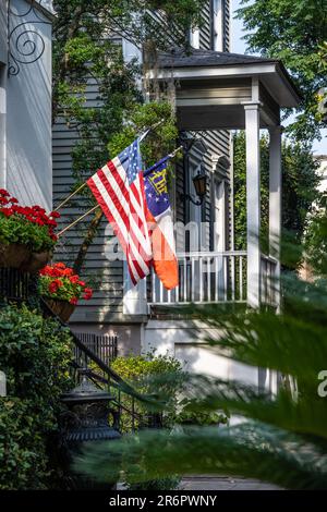 Porch flags at The Ballastone, a five-star rated luxury inn, on Oglethorpe Street in Savannah, Georgia's historic district. (USA) Stock Photo