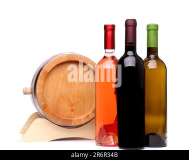 Three wine bottles and wodden barrel on a white background Stock Photo