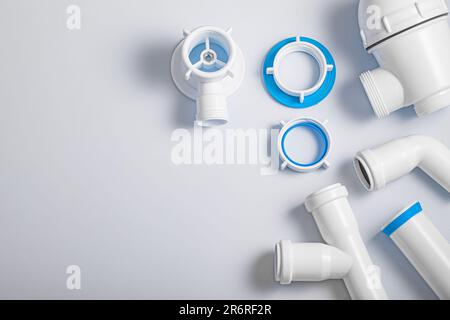 Plastic Sewer Pipes And Accessories On White Background Stock Photo