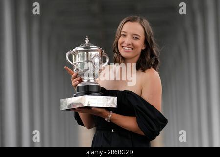 Poland's Iga Swiatek poses with her trophy in Paris, Sunday, June 11, 2023,  after winning the women's singles final match of the French Open tennis  tournament at the Roland Garros stadium Saturday. (